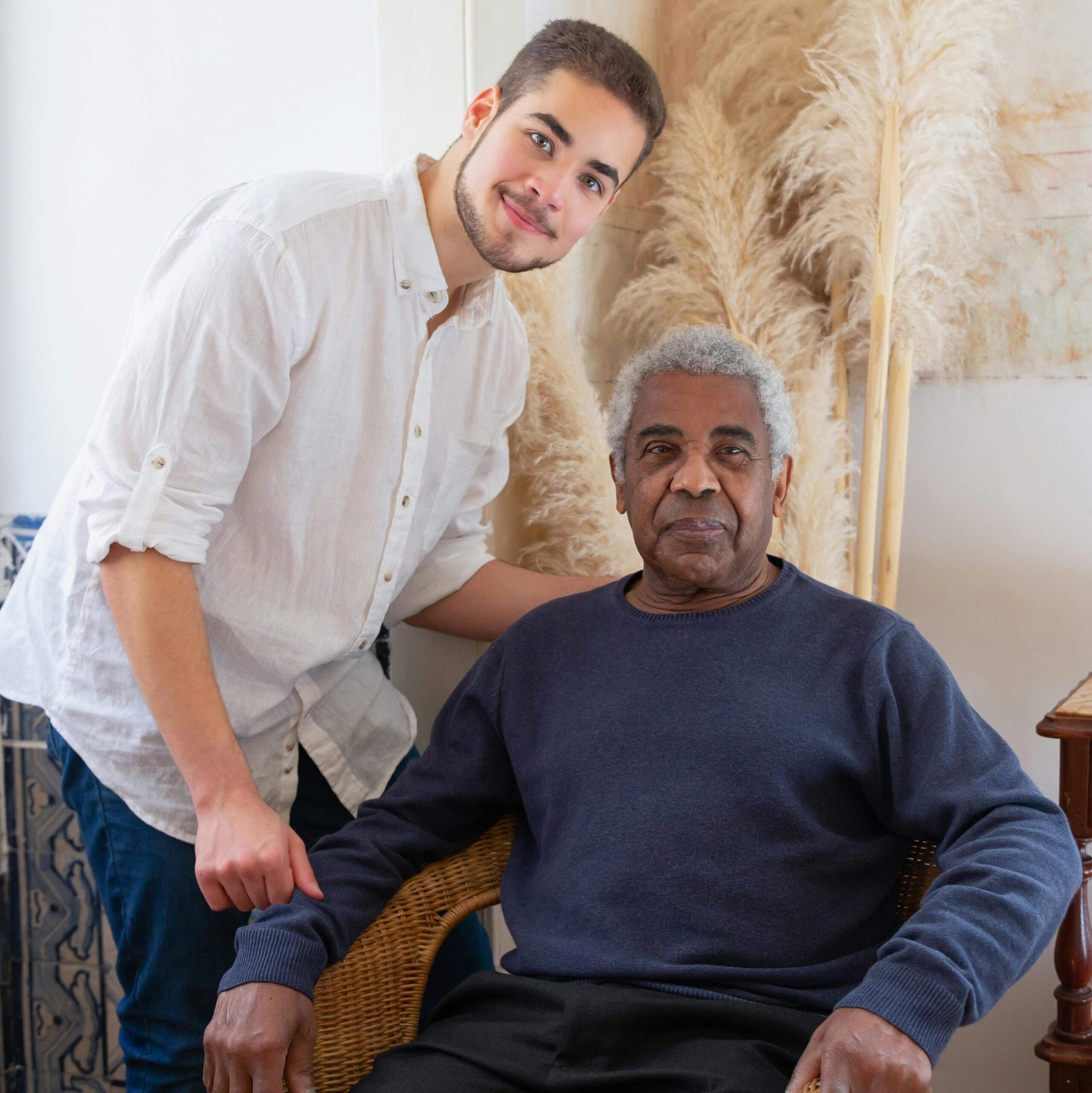 A young adult and senior man enjoying a moment in a cozy Portuguese living room.